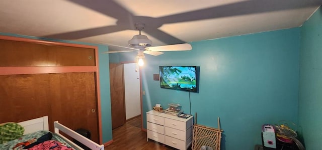 bedroom with ceiling fan and dark hardwood / wood-style flooring