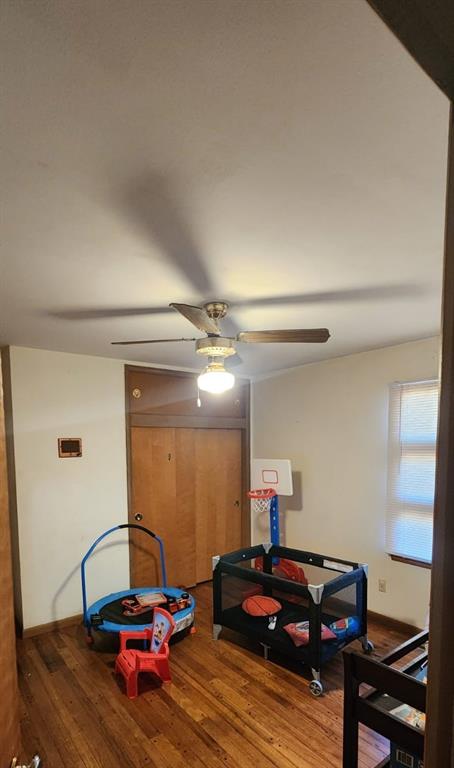 game room featuring hardwood / wood-style floors and ceiling fan