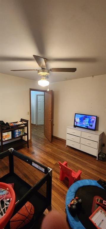 living room with ceiling fan and hardwood / wood-style floors