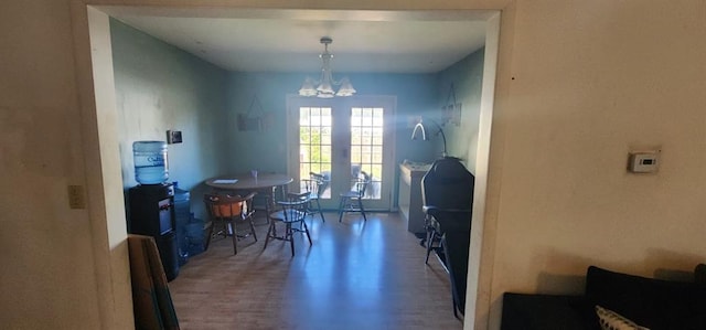 dining area featuring french doors and a notable chandelier