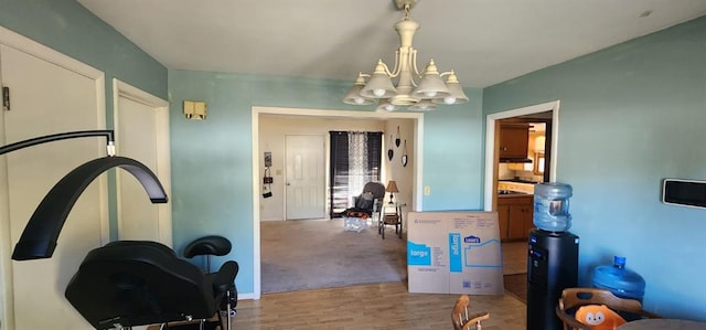 interior space with light hardwood / wood-style floors and an inviting chandelier