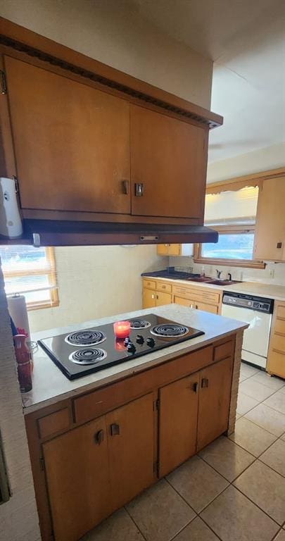 kitchen with dishwasher, light tile patterned floors, and black electric cooktop