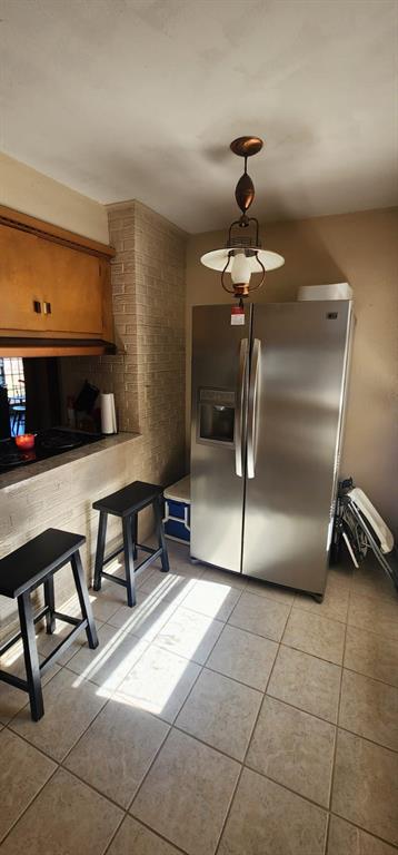 kitchen featuring stainless steel fridge and light tile patterned floors