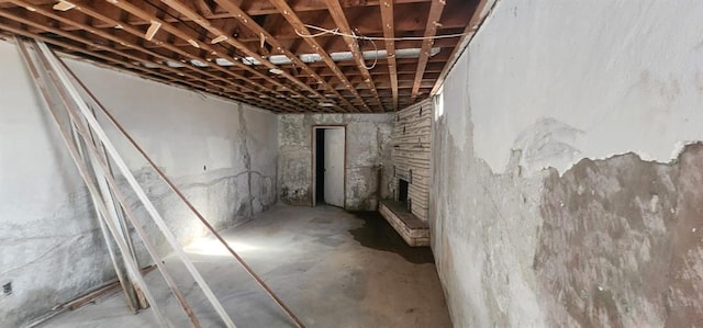 basement with a stone fireplace