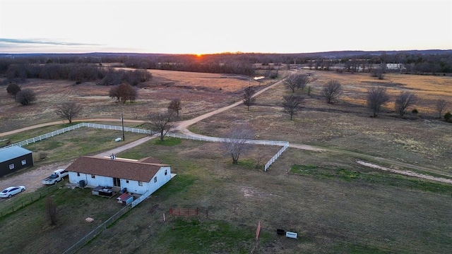 aerial view at dusk featuring a rural view