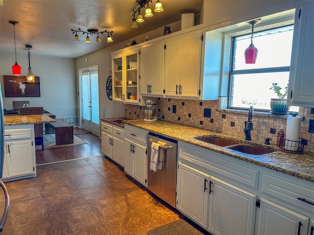 kitchen with hanging light fixtures, sink, dishwasher, white cabinets, and decorative backsplash