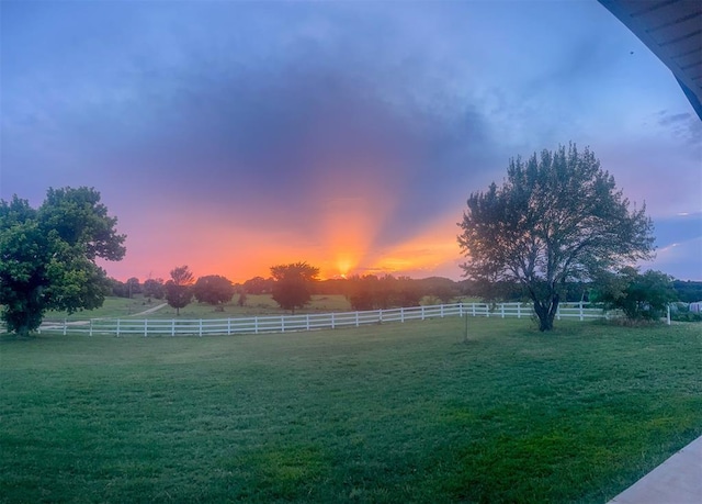 yard at dusk with a rural view