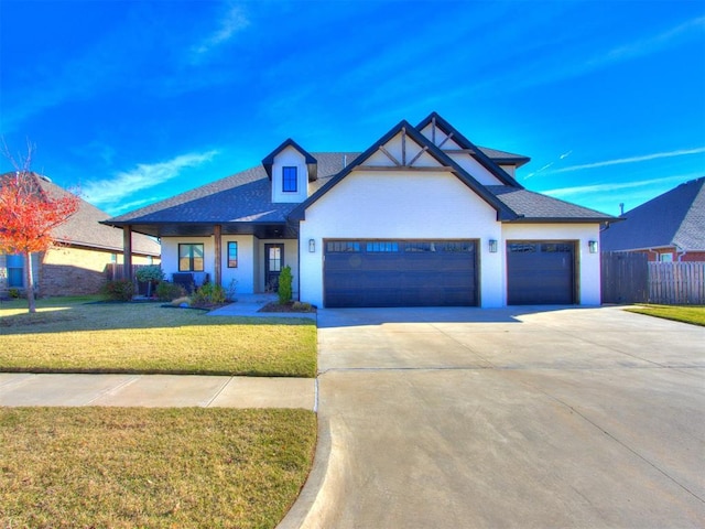 view of front facade with a garage and a front lawn