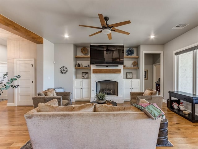 living room with light hardwood / wood-style floors and ceiling fan