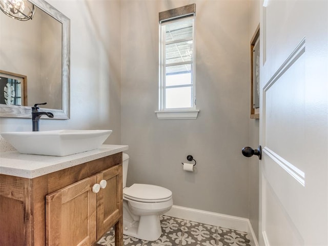 bathroom featuring tile patterned flooring, vanity, and toilet