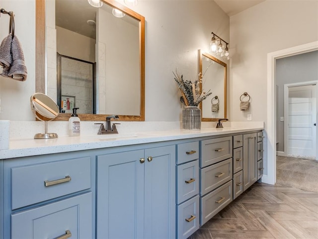 bathroom featuring vanity, parquet floors, and a shower with shower door