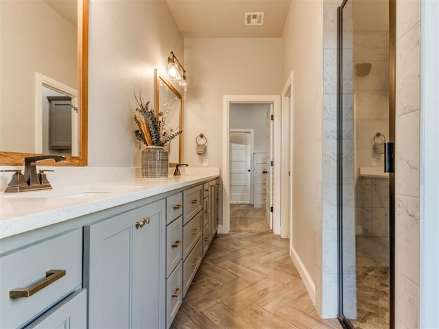 bathroom featuring walk in shower, vanity, and parquet floors