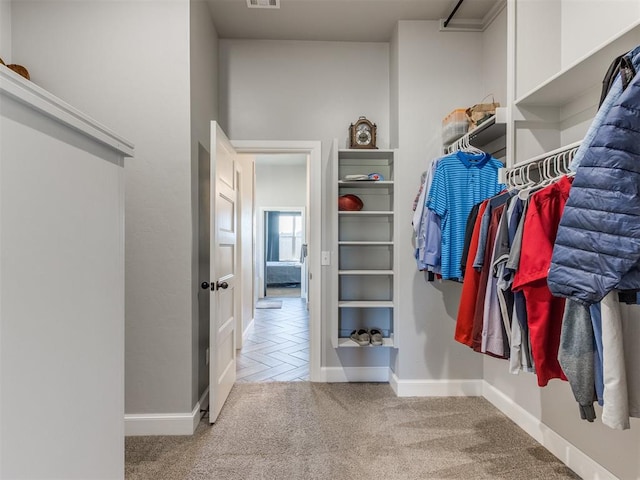 walk in closet with parquet floors