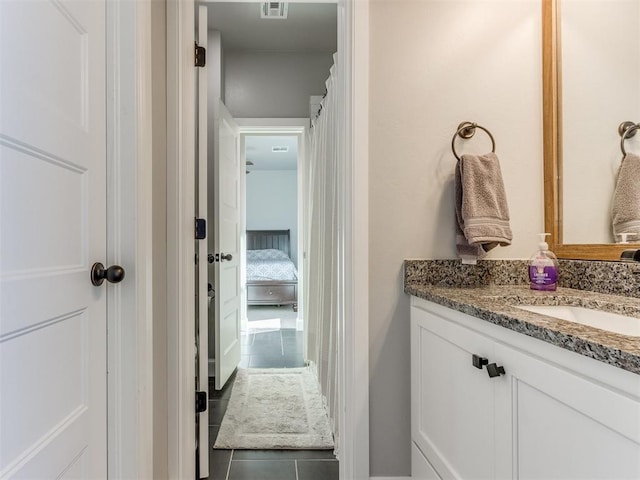 bathroom with tile patterned flooring and vanity