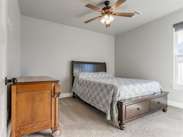 carpeted bedroom with multiple windows and ceiling fan