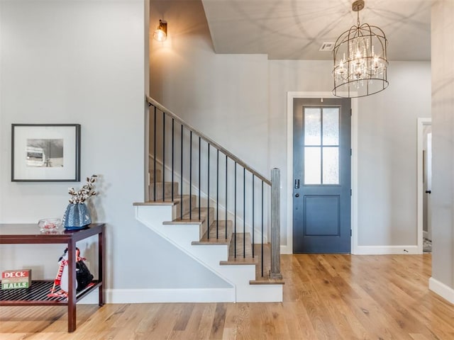 entrance foyer featuring hardwood / wood-style flooring and a chandelier