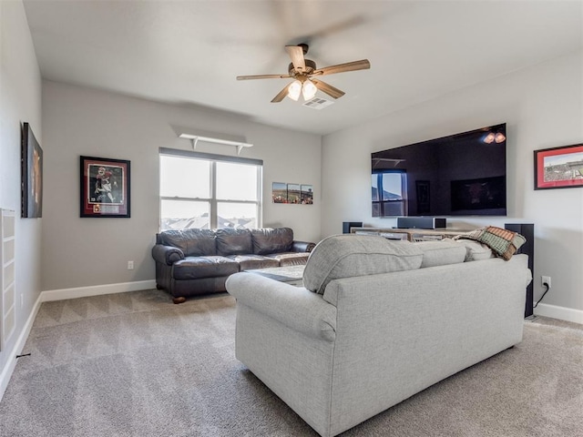 carpeted living room with ceiling fan