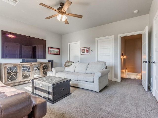 living room with ceiling fan and carpet