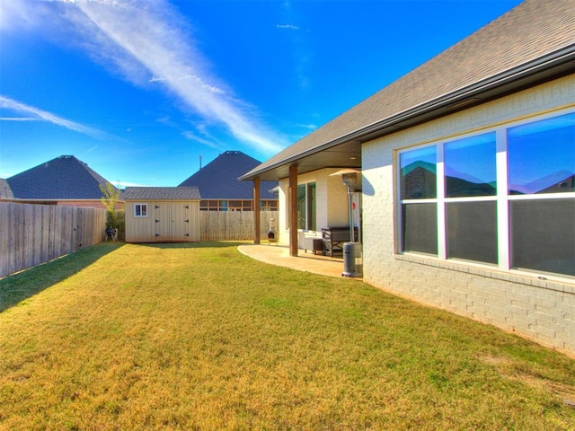 view of yard with a patio and a storage shed