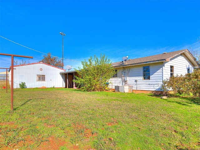 rear view of property featuring a lawn