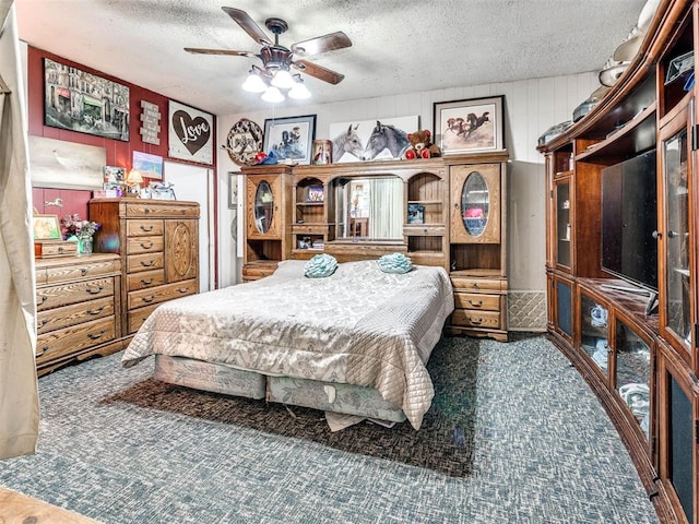 bedroom with ceiling fan and a textured ceiling