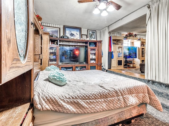 bedroom with a textured ceiling and ceiling fan