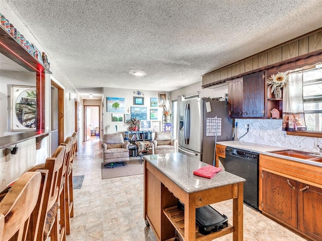 kitchen featuring decorative backsplash, stainless steel fridge with ice dispenser, black dishwasher, and a textured ceiling