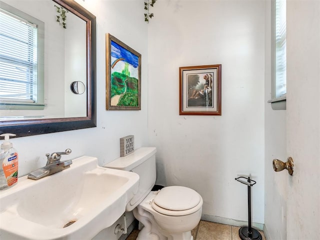 bathroom featuring tile patterned flooring, toilet, and sink