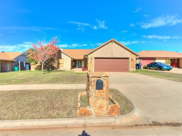 ranch-style house featuring a front yard and a garage