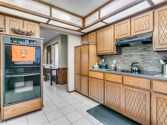 kitchen with black appliances, light tile patterned flooring, and backsplash