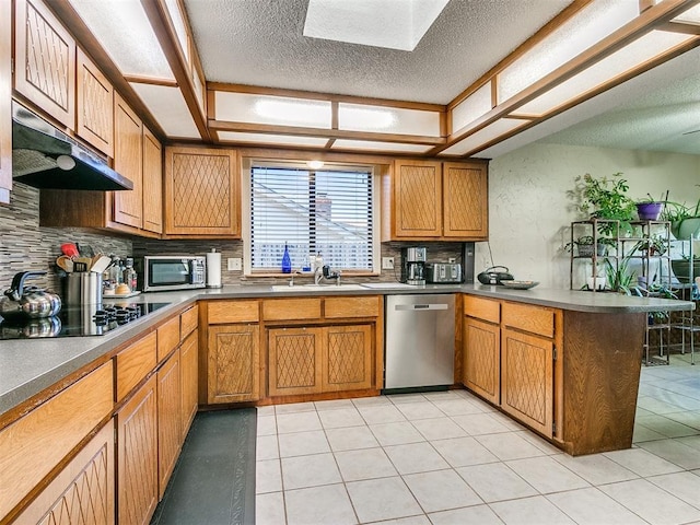 kitchen featuring kitchen peninsula, appliances with stainless steel finishes, backsplash, ventilation hood, and light tile patterned floors