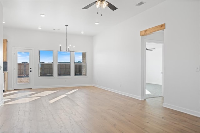 unfurnished room with recessed lighting, visible vents, light wood-type flooring, baseboards, and ceiling fan with notable chandelier