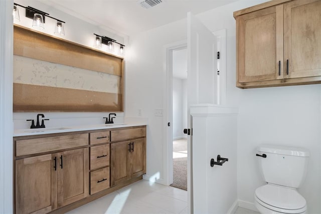 bathroom with tile patterned floors, vanity, and toilet