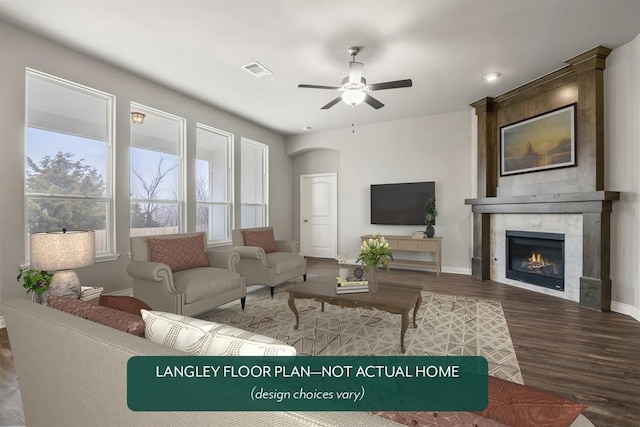 living room with a fireplace, ceiling fan, plenty of natural light, and hardwood / wood-style flooring