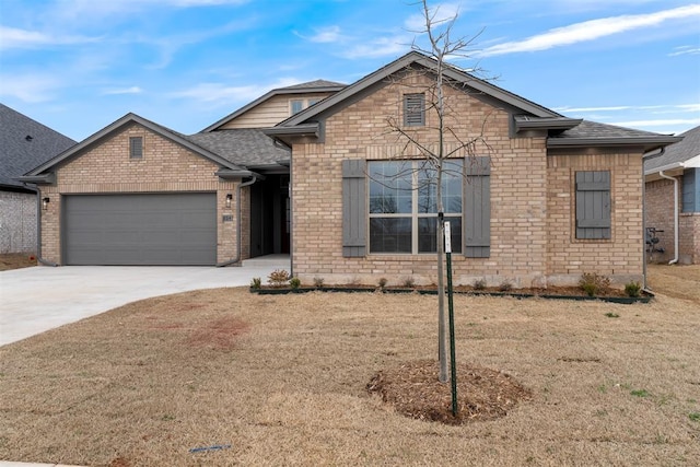 view of front of home with brick siding, a garage, driveway, and roof with shingles