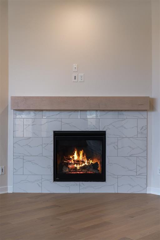 804 Argos Rd, Yukon, OK 73099 - detailed view of a warm lit fireplace and wood finished floors
