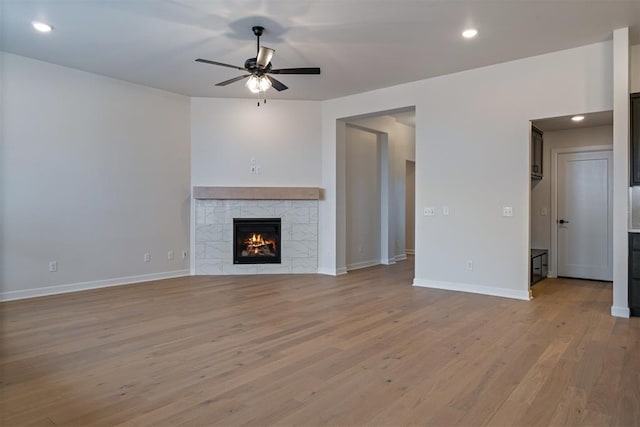 804 Argos Rd, Yukon, OK 73099 - unfurnished living room featuring a ceiling fan, light wood-style floors, a tile fireplace, and recessed lighting