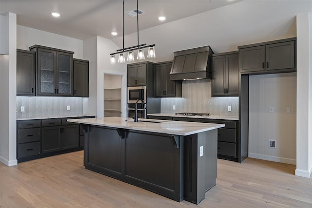 804 Argos Rd, Yukon, OK 73099 - kitchen featuring custom exhaust hood, appliances with stainless steel finishes, light wood-style floors, backsplash, and recessed lighting