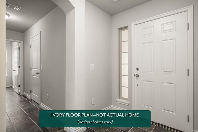 entryway with dark tile patterned floors