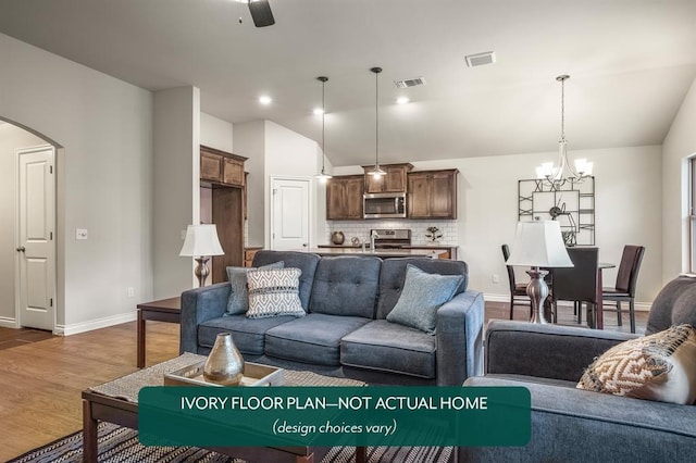 living room featuring lofted ceiling, sink, ceiling fan with notable chandelier, and dark hardwood / wood-style floors