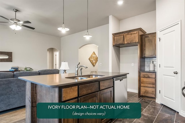 kitchen with dark brown cabinetry, ceiling fan, sink, and a kitchen island with sink