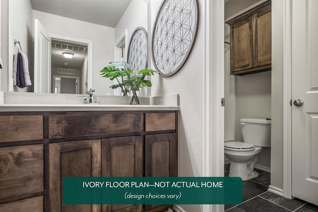 bathroom with tile patterned floors, vanity, and toilet