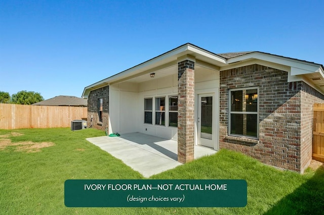 rear view of house with central AC unit, a yard, and a patio