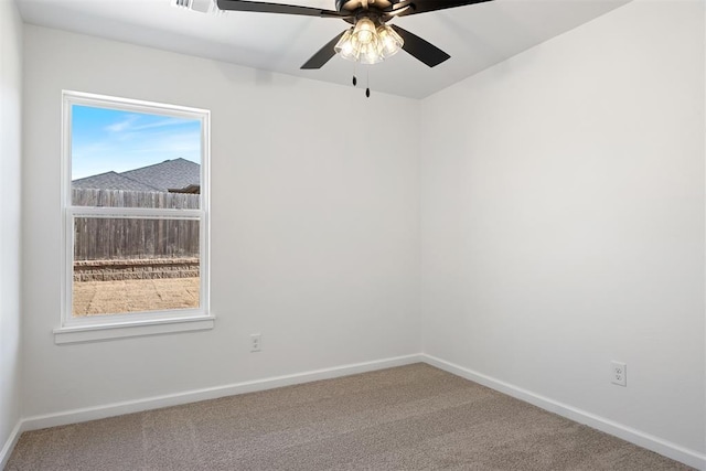 unfurnished room featuring ceiling fan and carpet