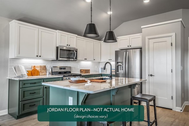 kitchen with white cabinetry, stainless steel appliances, vaulted ceiling, decorative backsplash, and a center island with sink