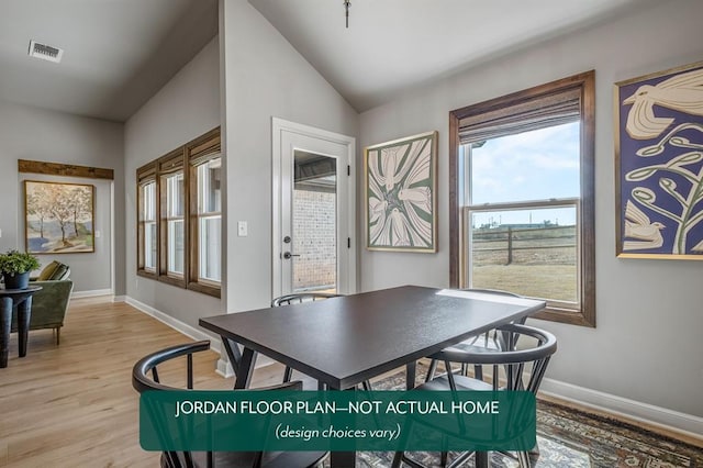 dining space featuring light hardwood / wood-style floors and vaulted ceiling