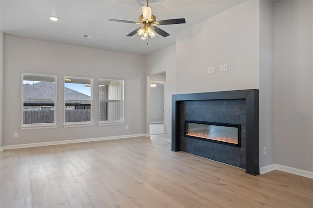 unfurnished living room featuring ceiling fan and light wood-type flooring