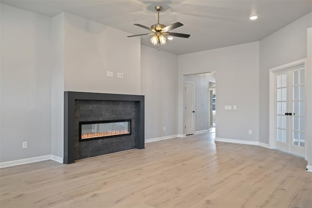 unfurnished living room with light hardwood / wood-style flooring and ceiling fan