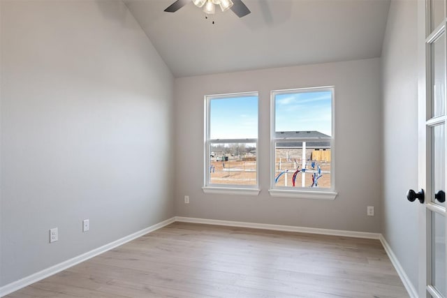 empty room with lofted ceiling, light hardwood / wood-style floors, and ceiling fan