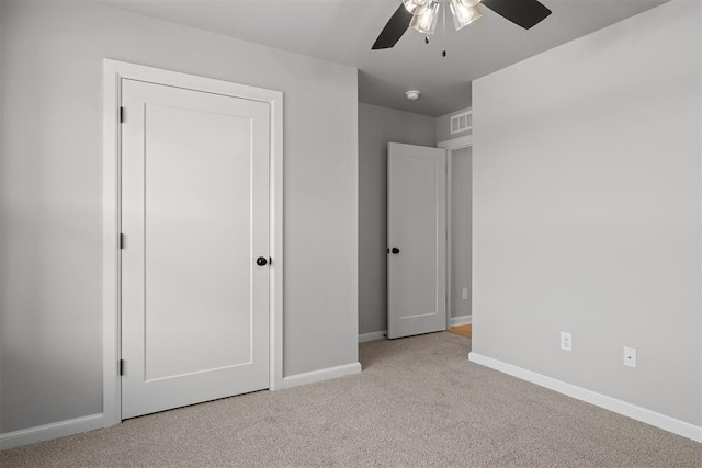 unfurnished bedroom featuring light colored carpet and ceiling fan